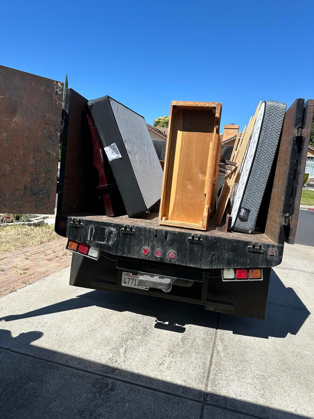 Divas junk removal truck carrying unwanted furniture and mattresses